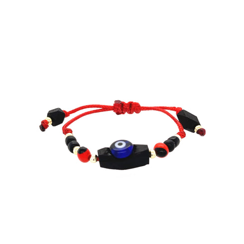 The Genuine Azabache Bracelet for Baby with Blue Evil Eye Peonia is handcrafted, showcasing a blue evil eye bead at its center for spiritual protection, surrounded by black and red beads. It is strung on an adjustable red rope with black and red accents at the ends.